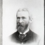 Serious bearded man with graying beard in Sunday best