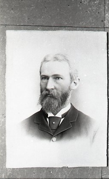 Serious bearded man with graying beard in Sunday best