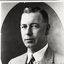Bryll creamed man looking serious in his three piece suit
