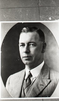 Bryll creamed man looking serious in his three piece suit