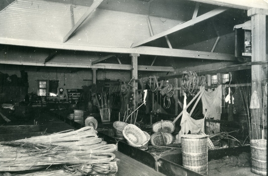 Cane stalks sit opposite finished cane baskets and twisted cane