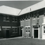 Man walking into brick 2 storey building