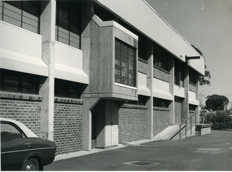 Double storey brick building with walkway to loading dock