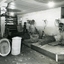 Four men making wicket baskets with some completed baskets displayed