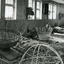Other side of workshop, with four men making wicker baskets
