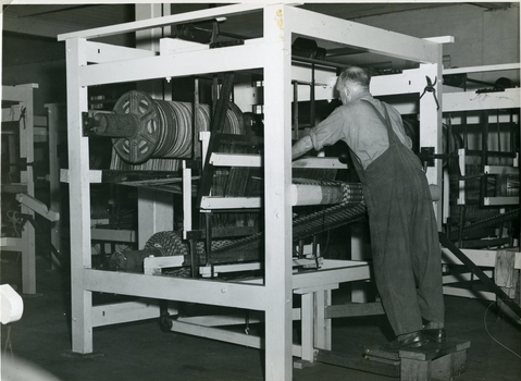 Man operating a coir matting machine