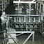 Man observing bobbin winder and bobbin bank