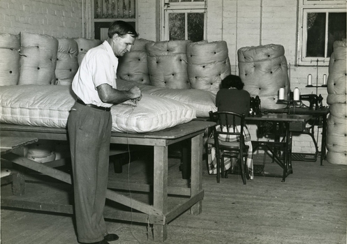 Male and female worker in the mattress shop