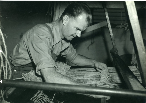 Mannix O'Reagan using a comb on a loom