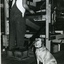 Arthur Bridges operating a mat making machine with his guide dog standing by