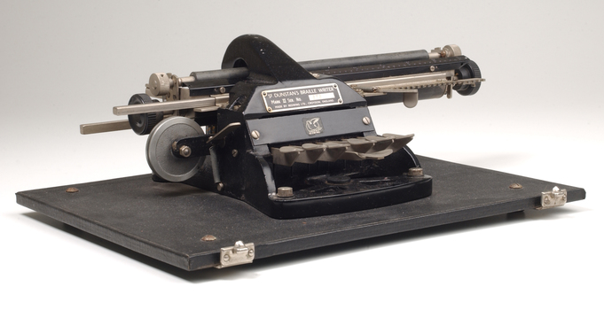 Metal Braille typewriter attached to rectangle base board