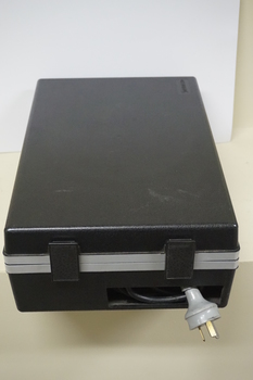 Closed black case with cord at end