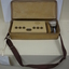 Tan rectangular box in vinyl bag