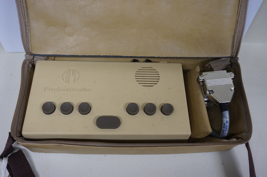 Tan rectangular box in vinyl bag