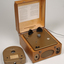 Wooden box with metal grill in front and two clasps.  A golden cartridge sits beside the player.