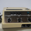 Plastic rectangular light brown audio player with buttons for navigational controls