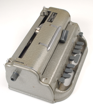 Metal Braille writer with nine grey keys, carriage return key and paper rollers on either side