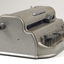 Metal Braille writer with nine grey keys, carriage return key and paper rollers on either side