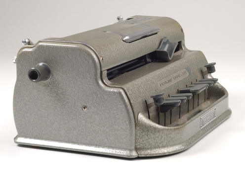 Metal Braille writer with nine grey keys, carriage return key and paper rollers on either side