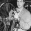 Mitchell cycle worker working on a wheel, with his hand on a spoke