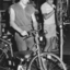 Two men working on bicycles in factory