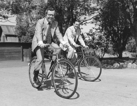 Two men riding Mitchell cycles