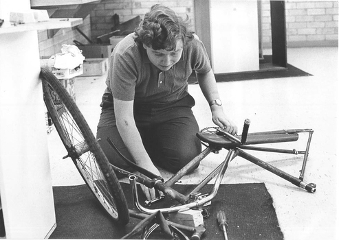 Worker assembling a bicycle on the factory floor