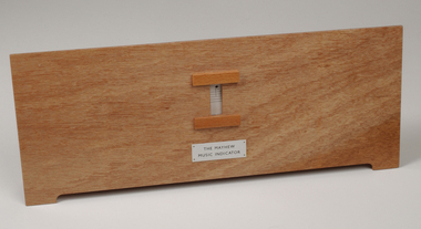 Front view of wooden board with gap in the middle showing music staff