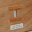 Front view of wooden board with gap in the middle showing music staff