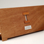 Front view of wooden board with gap in the middle showing music staff