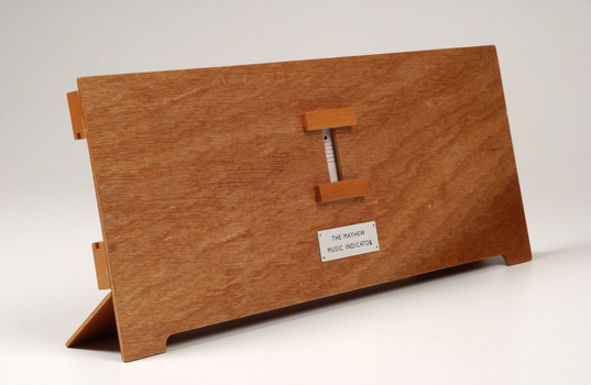 Front view of wooden board with gap in the middle showing music staff