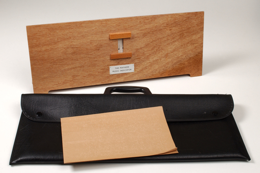 Front view of wooden board with gap in the middle showing music staff