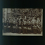 Large group of men and women, some holding instruments, outside the RVIB building.