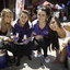 Group of staffers and Red Bull girls with black Labrador