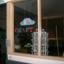 Craft sign in window of darkened room, made of large cut out letters