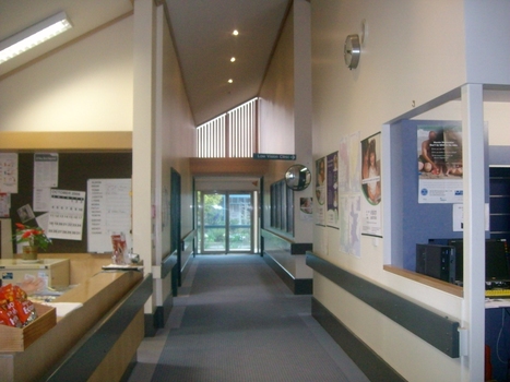 View down hallway from front area, past reception and towards centre manager office