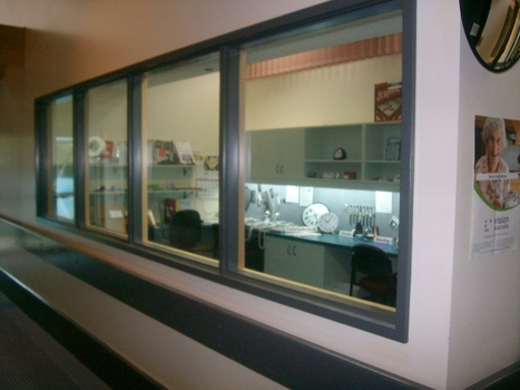 Looking through window to adaptive equipment shop and display