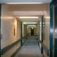 View down hallway from front left side of building down to orthoptist and gold edged portraits of Wicking and Daubney