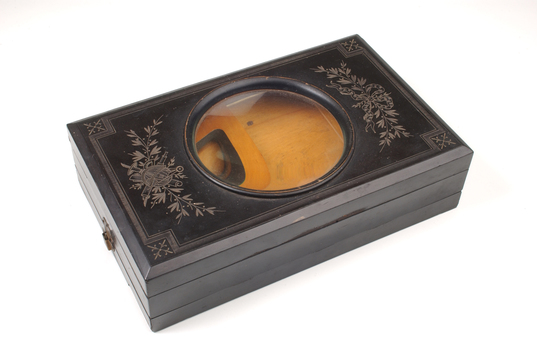 1 wooden box with fold out top and inset glass magnifier.
