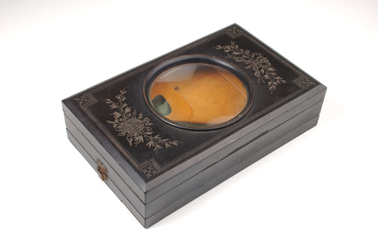 1 wooden box with fold out top and inset glass magnifier.