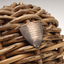 Braided wicker in ball shape with miniature metal shield attached