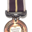 Silver medal hanging from burgundy ribbon
