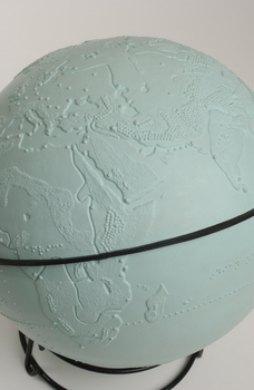 Light blue sphere with raised surfaces of various textures and braille writing