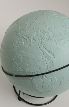 Light blue sphere with raised surfaces of various textures and braille writing