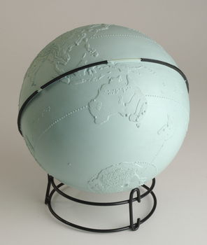 Light blue sphere with raised surfaces of various textures and braille writing