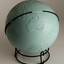 Light blue sphere with raised surfaces of various textures and braille writing