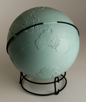 Light blue sphere with raised surfaces of various textures and braille writing
