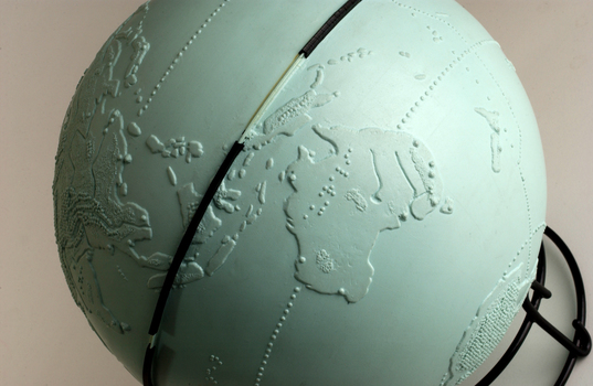 Light blue sphere with raised surfaces of various textures and braille writing