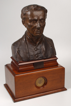 Bronze bust of Louis Braille on wooden mount
