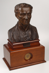 Bronze bust of Louis Braille on wooden mount